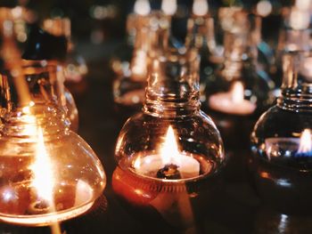 Close-up of illuminated candles on table