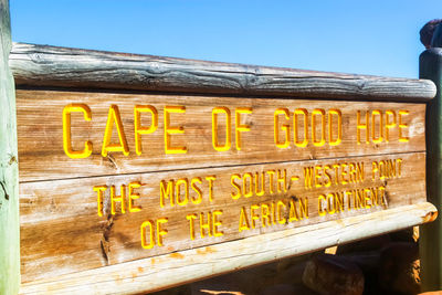 Text written on wood against clear sky