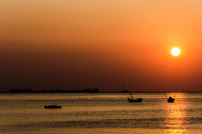 Scenic view of sea against orange sky