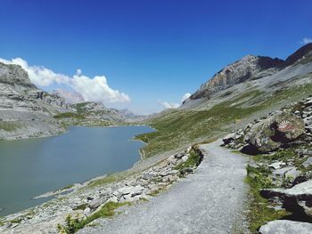 Scenic view of river amidst mountains against sky