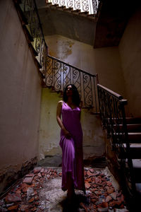 Portrait of young woman sitting on staircase