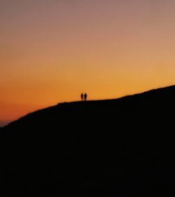 Scenic view of silhouette landscape against sky at sunset