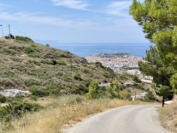 Road by sea against sky in city