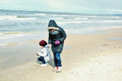 Girls playing on sand at beach