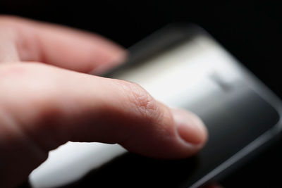 Close-up of hand holding mobile phone