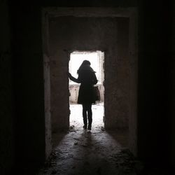Full length of woman standing by railing