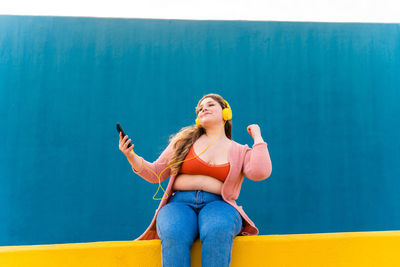 Portrait of young woman with mobile phone