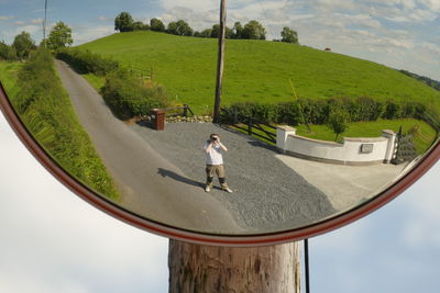 Rear view of man walking on road