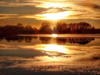 Scenic view of lake against sky during sunset