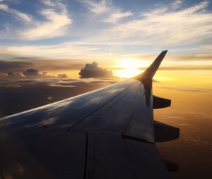 Cropped image of airplane flying over clouds