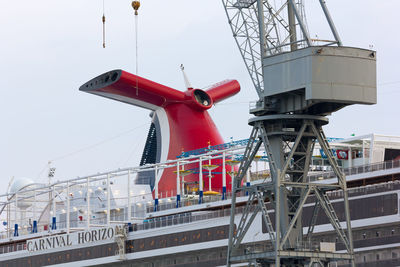 Low angle view of crane against clear sky