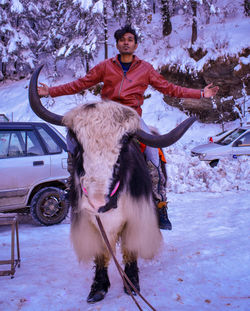 Portrait of young man riding horse