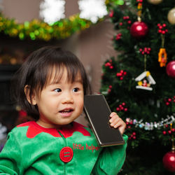 Girl in costume holding mobile phone at home