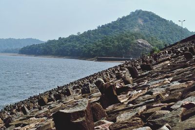 Scenic view of sea with mountain in background
