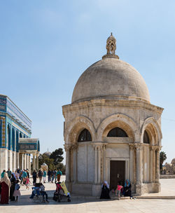 Group of people in front of historical building