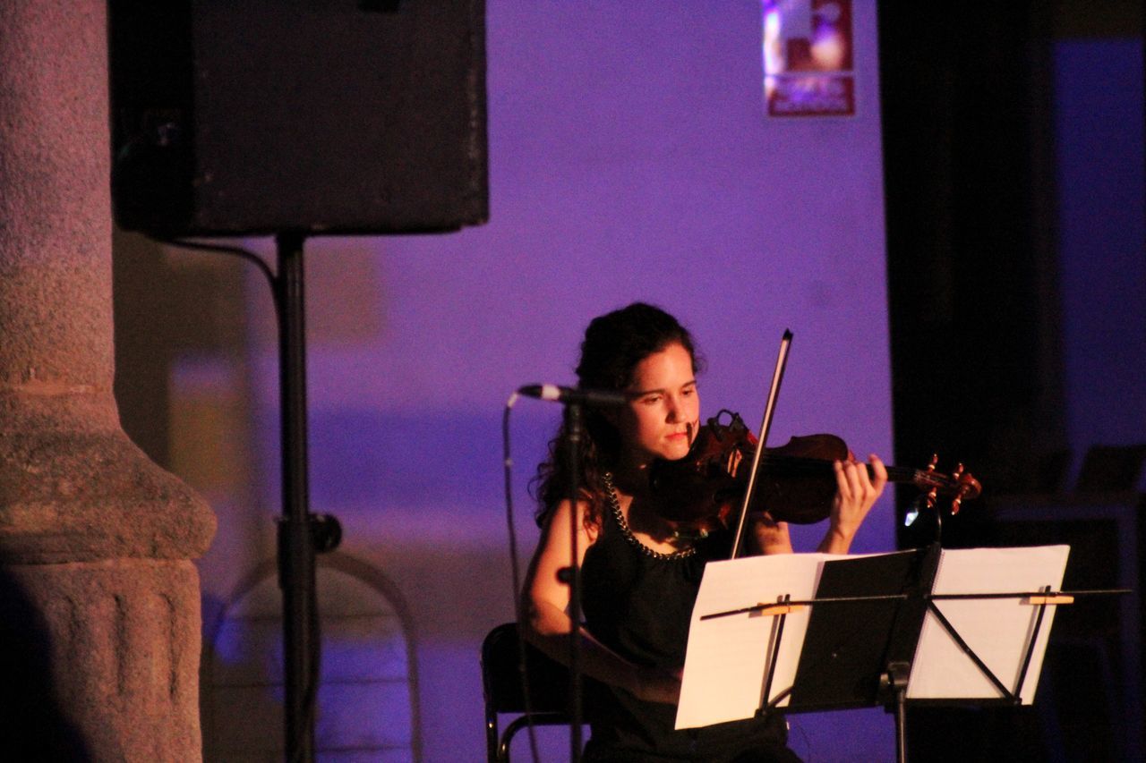 music, arts culture and entertainment, musician, performance, musical instrument, concert, entertainment, violin, indoors, string instrument, adult, singing, one person, musical equipment, women, performing arts event, performing arts, skill, stage, performance art, practicing, young adult, sitting, sheet, violinist, sheet music, concentration, microphone, input device, classical music