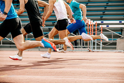 Low section of athlete running on track