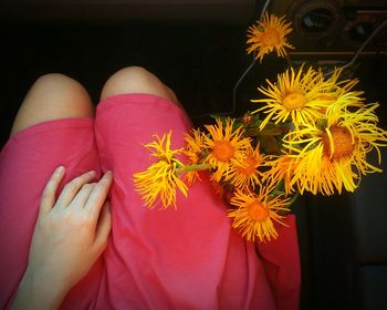 Low section of woman with flowers