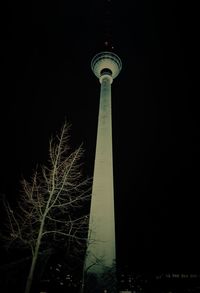 Low angle view of tower against sky at night