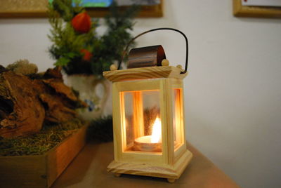 Close-up of illuminated lamp on table at home