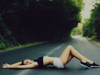 Woman lying on road