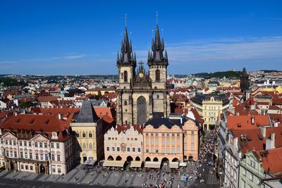 Buildings in city against blue sky