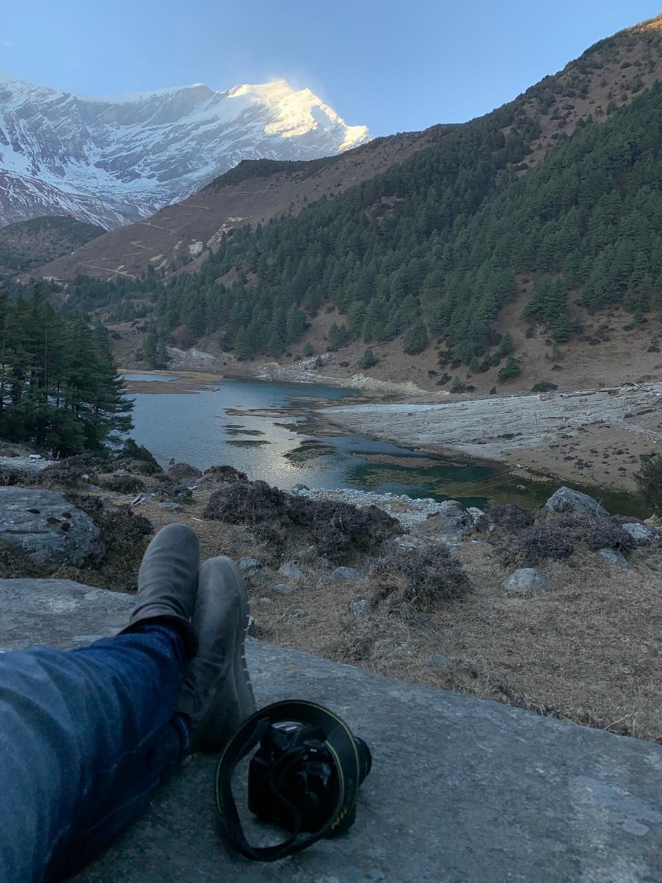 mountain, one person, real people, human body part, body part, scenics - nature, low section, beauty in nature, water, leisure activity, day, human leg, lifestyles, shoe, non-urban scene, mountain range, nature, tranquil scene, outdoors