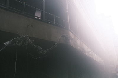 Low angle view of rope hanging on window