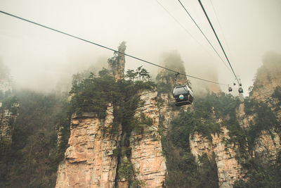 High angle view of overhead cable cars against sky