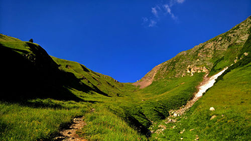 Scenic view of mountains against clear blue sky