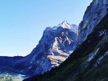 Scenic view of mountains against clear blue sky