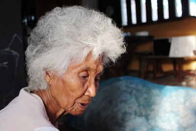 Close-up portrait of a woman at home