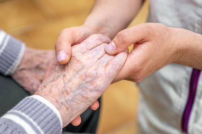 Cropped image of couple holding hands