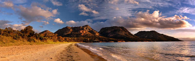 Panoramic view of sea and mountains against sky