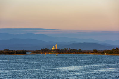 Sunset on the grado marano lagoon and a glimpse of the island of barbana.