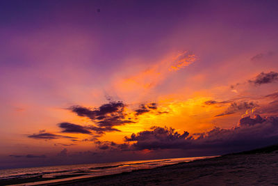 Scenic view of sea against romantic sky at sunset