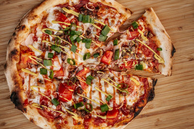 High angle view of pizza on cutting board