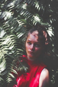 Portrait of woman looking at tree