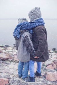 Low section of friends standing on snow