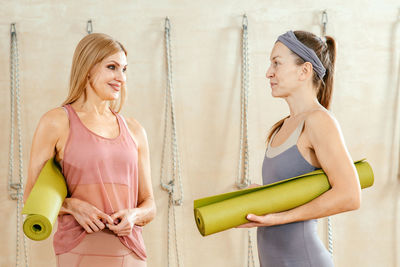 Woman talking while standing in gym