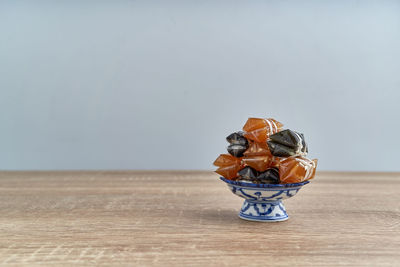 Close-up of fruits on table against white background