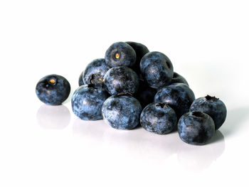 Close-up of blueberries against white background