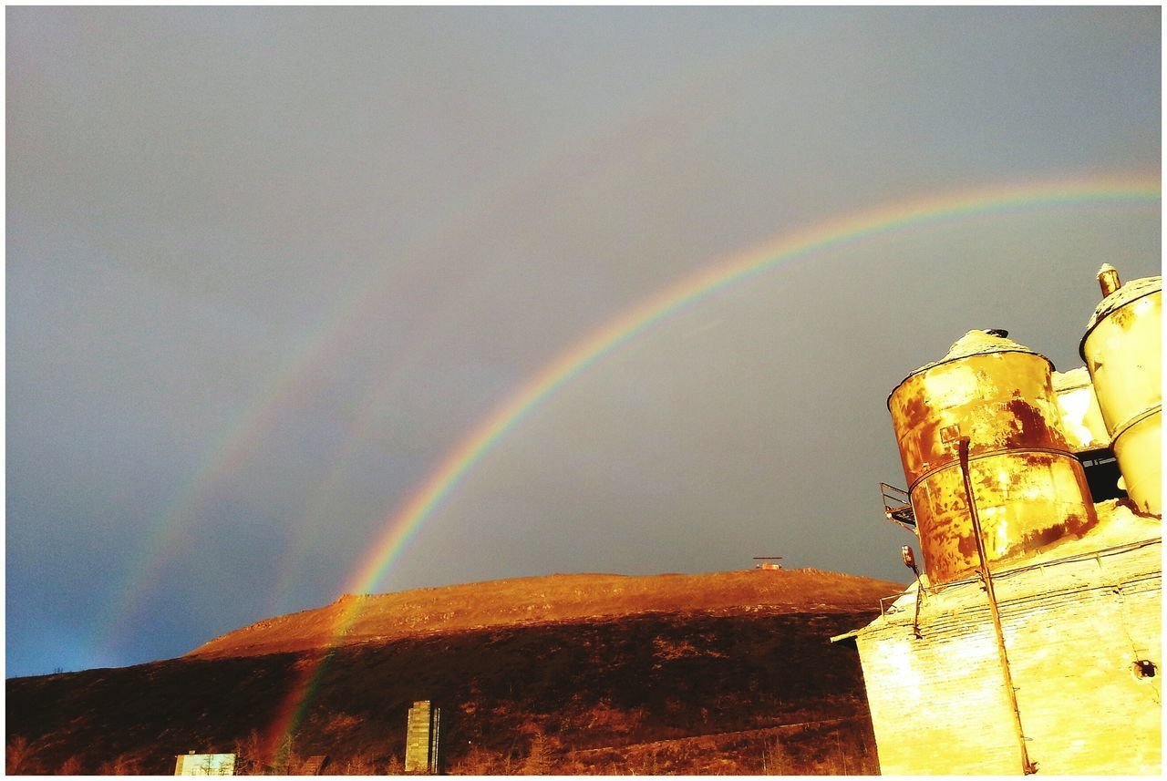 LOW ANGLE VIEW OF RAINBOW OVER BUILDING