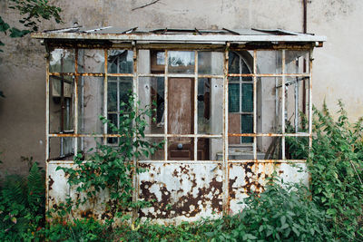 Damaged window of old abandoned building