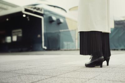 Low section of woman standing on bus