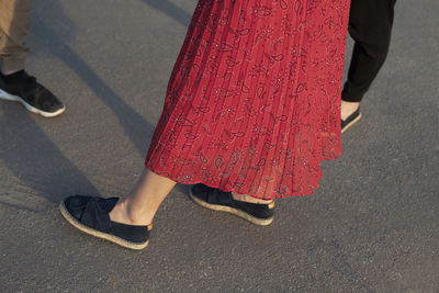 Low section of woman walking on road