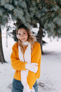 Teen blonde in a yellow sweater outside in winter. a teenage girl on a walk in winter clothes