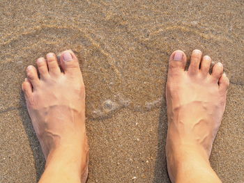 Low section of man legs on sand