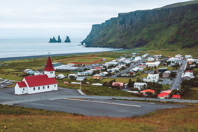 High angle view of townscape by sea against sky