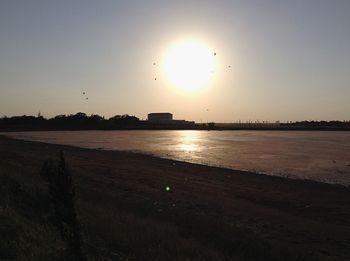 Scenic view of silhouette field against sky during sunset